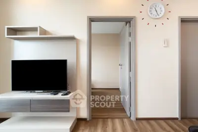 Modern living room with sleek TV unit and wooden flooring