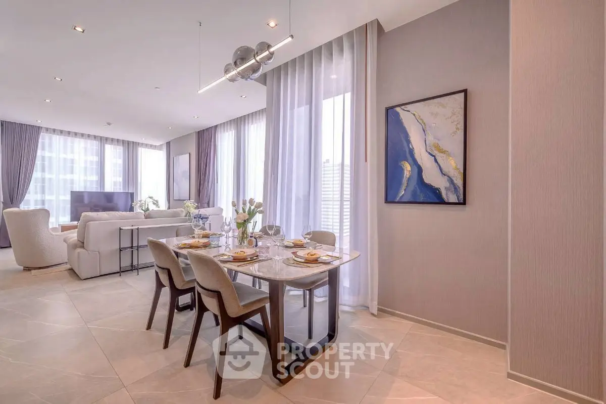 Luxurious open-plan living and dining area with elegant decor and large windows