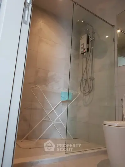 Modern bathroom with glass shower enclosure and sleek fixtures