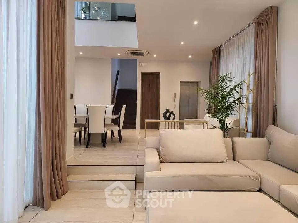 Spacious modern living room with elegant dining area and neutral decor