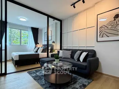 Modern studio apartment with stylish living area and cozy bedroom, featuring elegant decor and natural light.