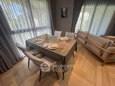 Elegant dining area with natural light and modern decor in a stylish living room setting.