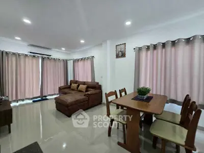 Spacious living room with cozy seating and dining area, perfect for family gatherings.