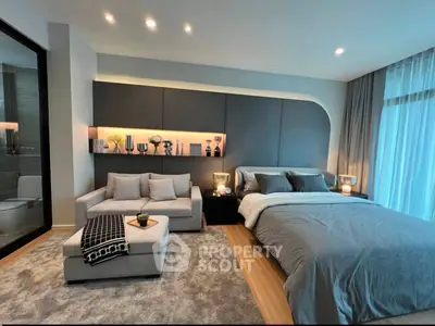 Luxurious modern bedroom with elegant decor and cozy seating area, perfect for relaxation and comfort.