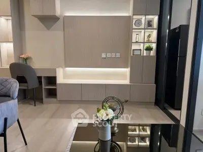 Modern living room with stylish decor and built-in shelving, featuring elegant lighting and a sleek design.