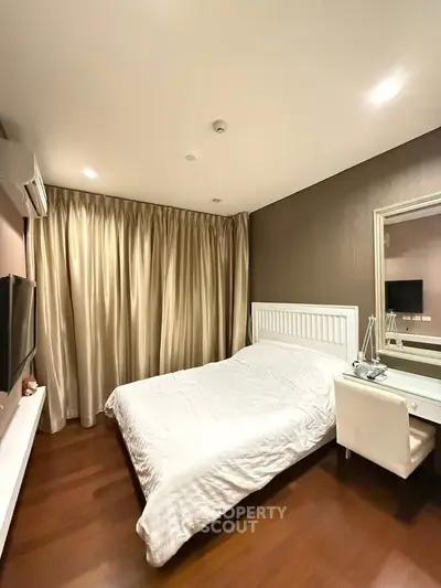 Cozy bedroom with elegant decor and natural light, featuring a comfortable bed and stylish furnishings.