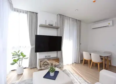 Modern living room with natural light, stylish furniture, and sleek decor