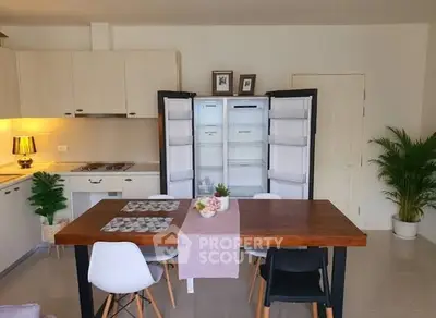 Modern dining area with open fridge and stylish decor