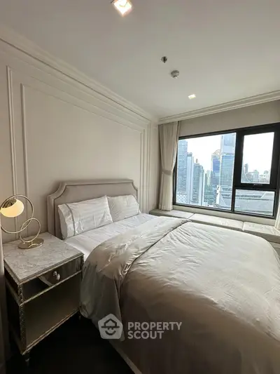 Luxurious bedroom with city view, elegant decor, and natural light in modern high-rise apartment.