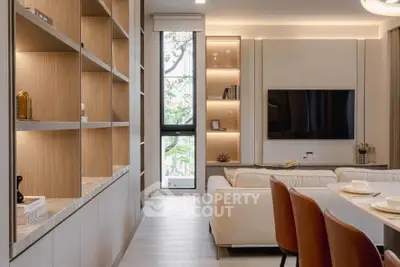 Modern living room with stylish shelving, large TV, and elegant dining area, perfect for contemporary living.