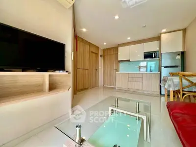 Modern living room with open kitchen and stylish furniture in a bright apartment.