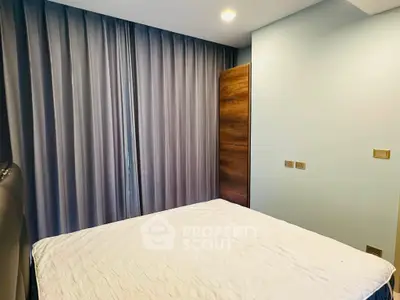 Cozy bedroom with modern design and ample natural light, featuring elegant curtains and a comfortable bed.
