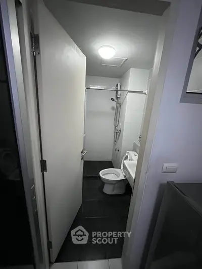 Compact bathroom with modern fixtures and shower in a real estate property.