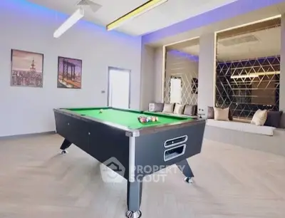 Luxurious game room with modern pool table and stylish decor