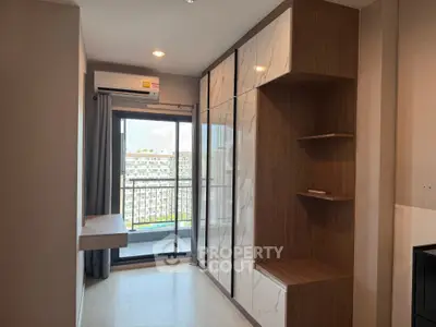 Modern condo bedroom with built-in storage and balcony view