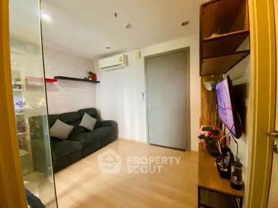 Cozy living room with modern decor and wall-mounted TV in a stylish apartment.