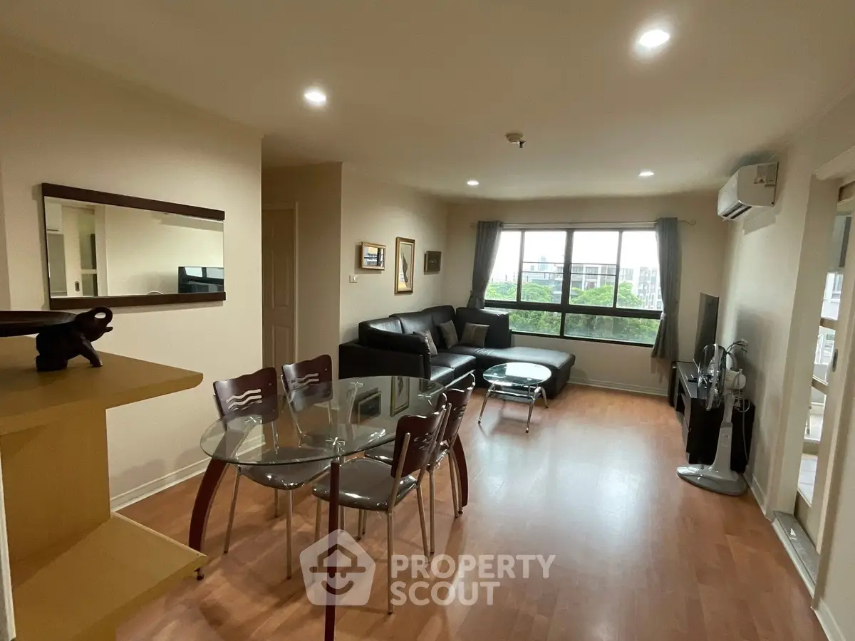 Spacious living room with modern furniture and large window view