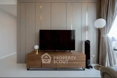 Modern living room with sleek TV stand and floor-to-ceiling windows