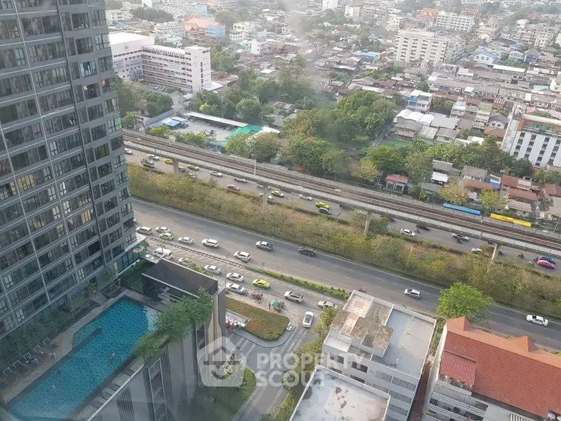 Stunning cityscape view from high-rise building with pool and busy roads below.