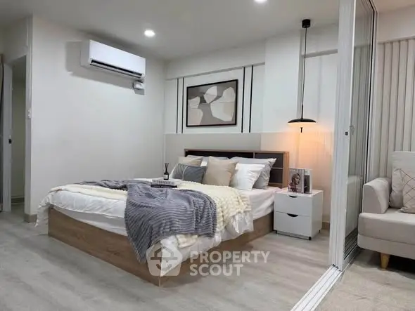 Modern bedroom with stylish decor and cozy ambiance, featuring a comfortable bed and elegant lighting.