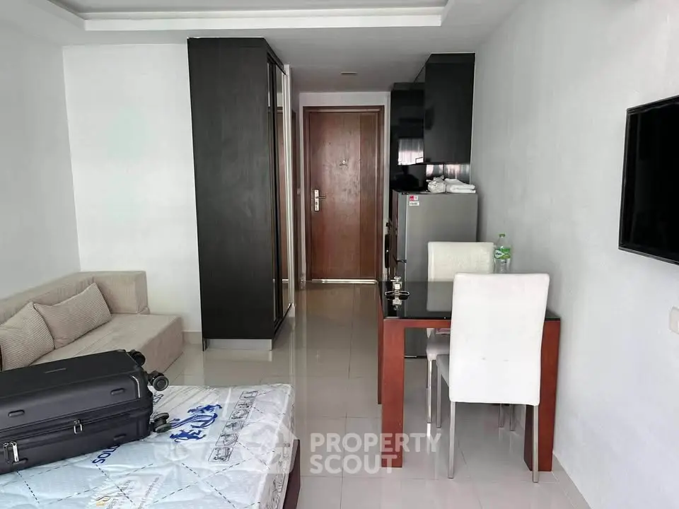 Modern studio apartment with sleek furniture and compact design, featuring a cozy living area and dining space.