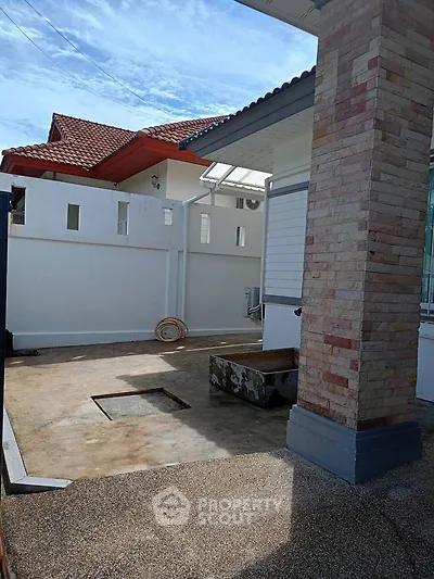 Charming exterior view of a modern home with brick accents and spacious patio area.