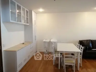 Spacious dining area with modern white furniture and wooden flooring