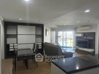 Modern living room with sleek furniture and city view balcony