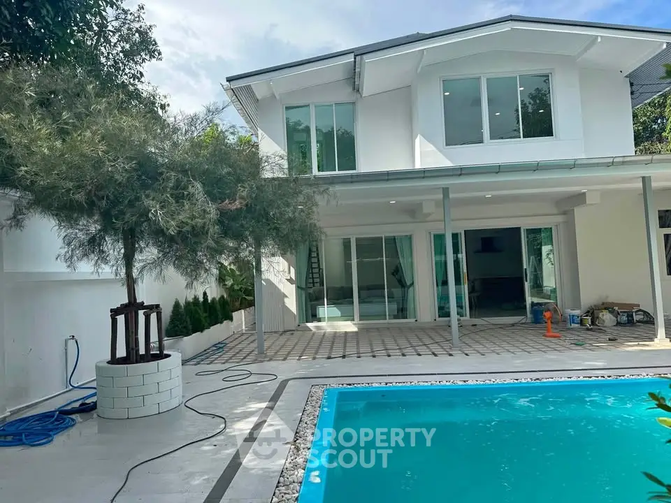 Modern two-story house with pool and spacious patio, perfect for luxury living.