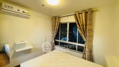 Cozy bedroom with city view, air conditioning, and elegant curtains.