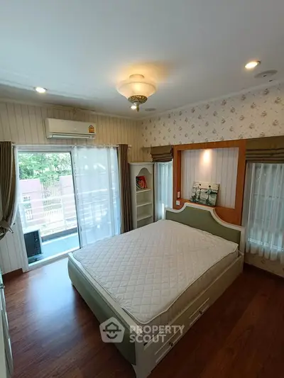 Charming bedroom with balcony access and elegant decor