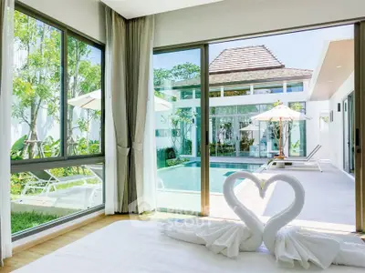 Luxurious bedroom with pool view and elegant decor in modern villa