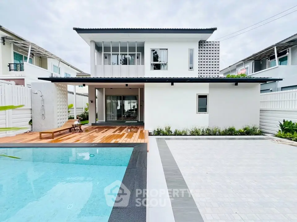 Modern two-story house with pool and spacious patio in a serene neighborhood.