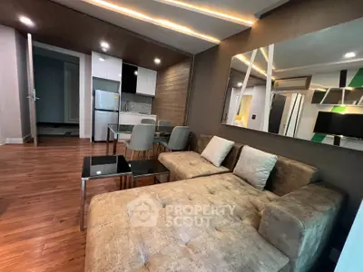 Modern living room with stylish furniture and open kitchen layout in a contemporary apartment.