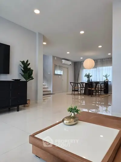 Spacious modern living room with elegant dining area and stylish decor