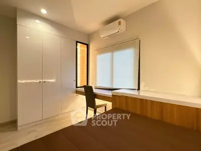 Modern bedroom with sleek built-in wardrobe and cozy ambiance