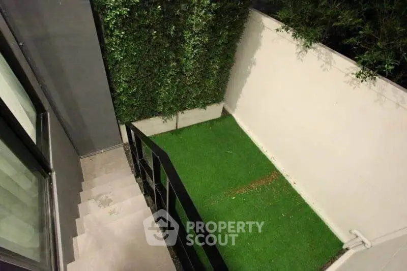 Modern townhouse with private garden and sleek staircase, perfect for urban living.