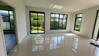 Spacious modern living room with large windows and garden view