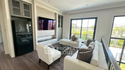 Elegant living room with modern furniture and large windows offering a scenic view.