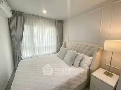 Elegant bedroom with plush bed and soft lighting in modern apartment