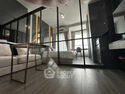 Modern bedroom with glass partition and sleek furnishings