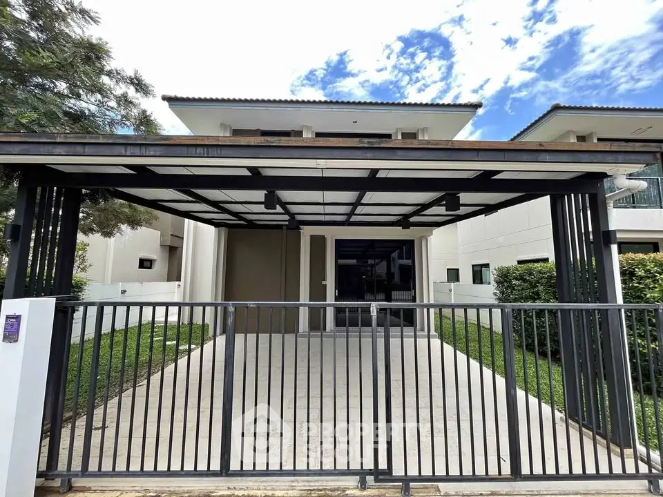 Modern house exterior with spacious driveway and sleek gate design