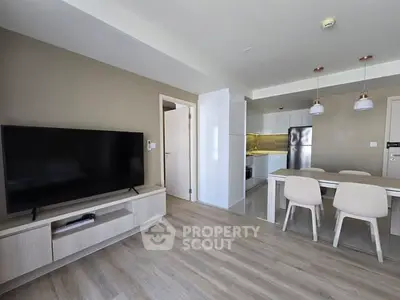 Modern open-plan living room with sleek kitchen and dining area