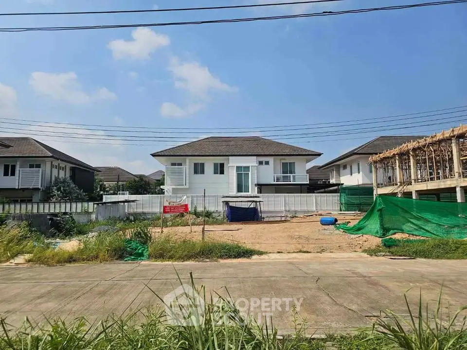 Modern suburban house with spacious yard under clear blue sky