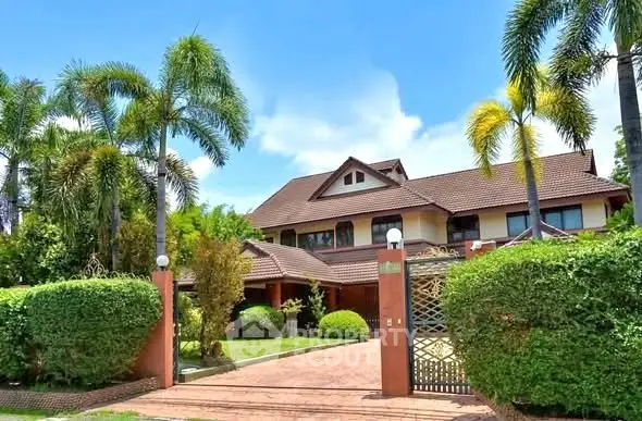 Stunning tropical villa with lush garden and palm trees, perfect for luxurious living.