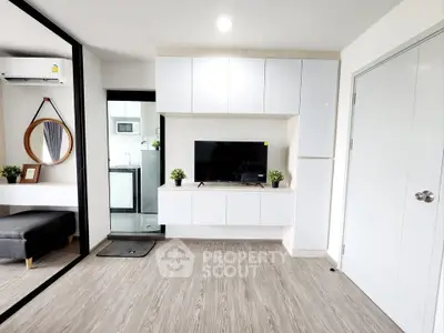 Modern living room with sleek cabinetry and stylish decor in a contemporary apartment.