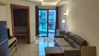 Modern living room with sleek furniture and pool view balcony in a stylish apartment.