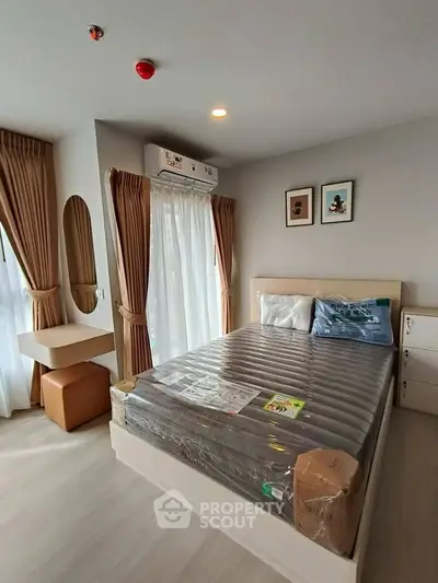 Modern bedroom with natural light, stylish decor, and cozy ambiance in a contemporary apartment.