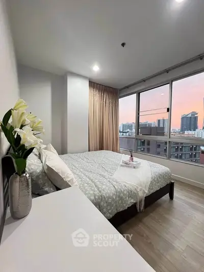 Modern bedroom with city view and elegant decor in high-rise apartment
