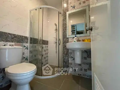 Modern bathroom with glass shower and stylish tiles